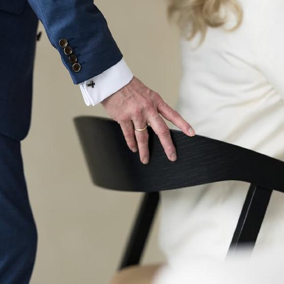 Photo by Stoppelenburg Uitvaart on January 22, 2026. May be an image of cufflinks, suit, chair, dinner jacket and text.